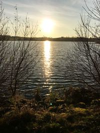 Scenic view of lake against sky during sunset