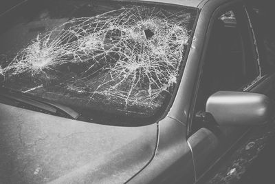 Reflection of built structure on glass of car