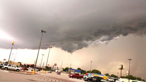 Parking lot against cloudy sky