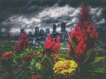 View of cityscape against cloudy sky