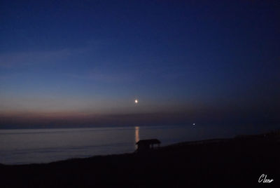 Scenic view of sea against sky at night