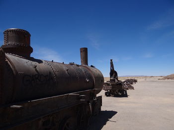 Old rusty ship against blue sky