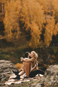 Woman sitting on rock