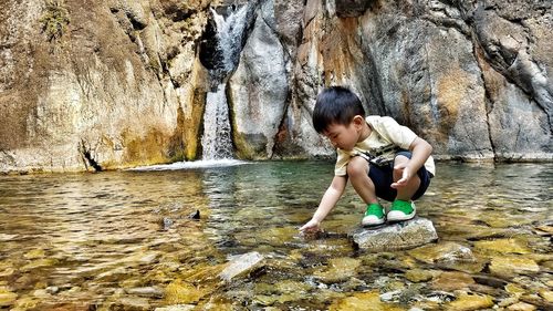 Boy playing in river