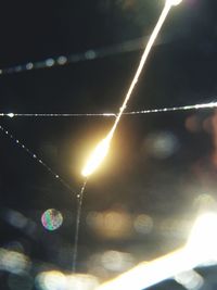 Low angle view of illuminated lights at night