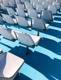 High angle view of empty chairs by swimming pool