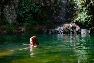 Woman swimming in lake