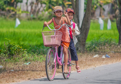 Woman riding bicycle on basket