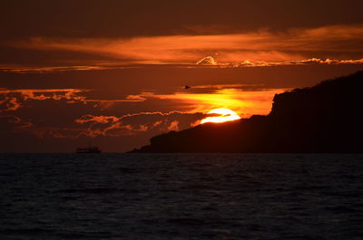 Scenic view of sea against orange sky