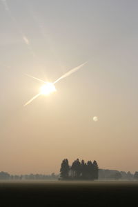 Scenic view of field against sky during sunset