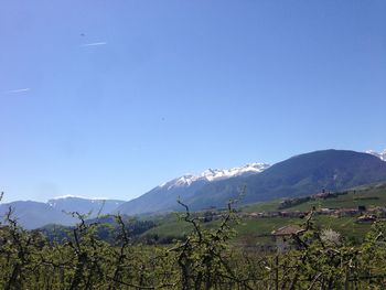 Scenic view of mountains against clear blue sky