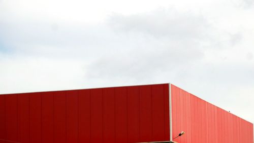 Red factory against sky