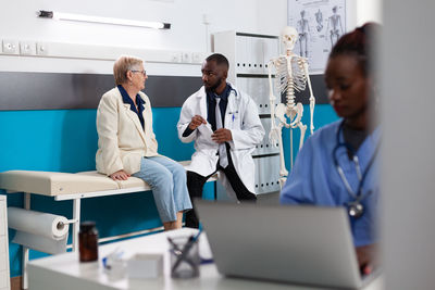 Doctor examining patient in clinic