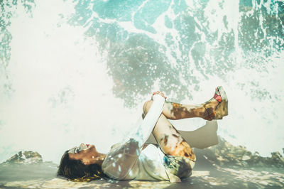 People in swimming pool against sea