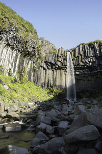 View of waterfall against clear sky