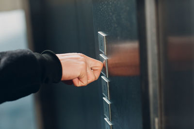 Midsection of man holding window