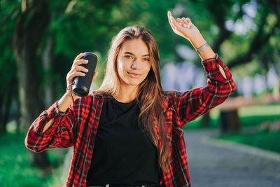 Portrait of smiling young woman standing outdoors