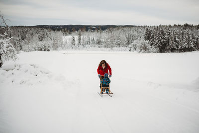 Rear view of man on snow covered field