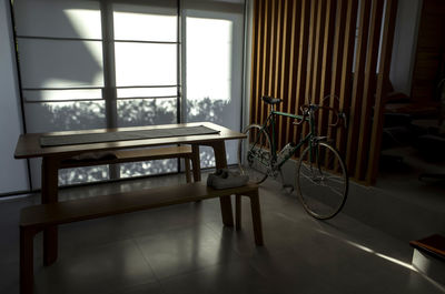 Shoes on bench by bicycle at home