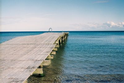 Scenic view of sea peer against sky