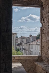 View of cityscape against cloudy sky