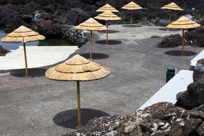 Umbrellas on rock by water