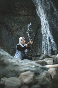 A woman lifts clear river water