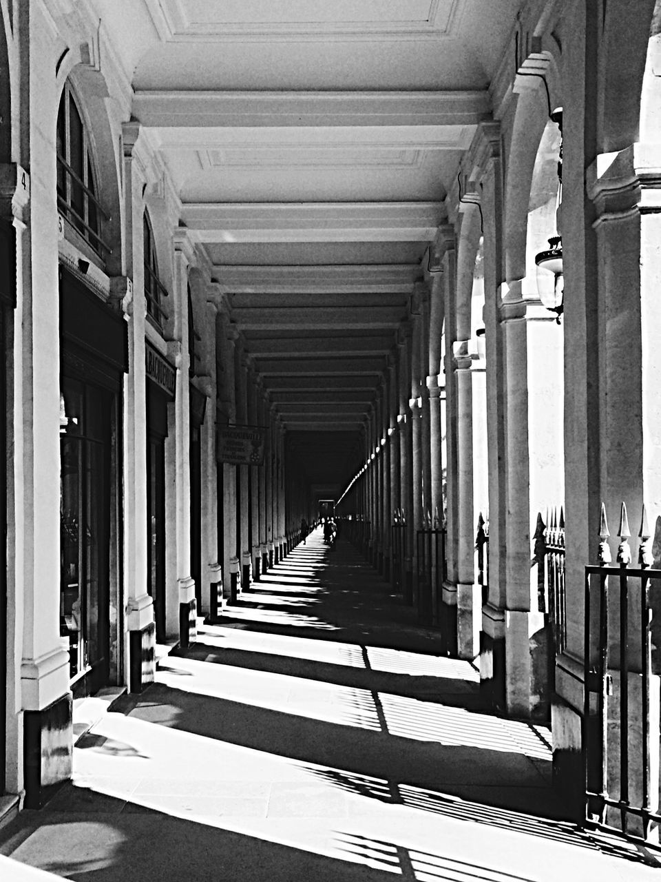 architecture, built structure, in a row, the way forward, architectural column, column, colonnade, diminishing perspective, indoors, corridor, railing, vanishing point, repetition, building, building exterior, pillar, arch, sunlight, day, support