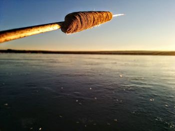 Close-up of water on shore against sky