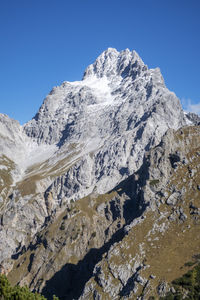 Scenic view of snowcapped mountains against clear blue sky