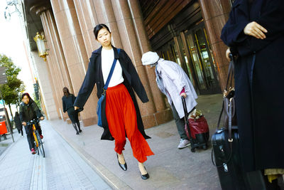 People walking on zebra crossing in city