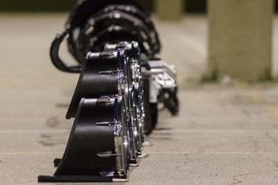 Close-up of bicycle on footpath in city