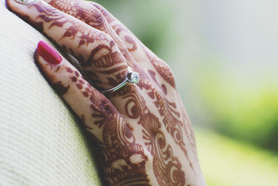 Close-up of henna tattoo on woman hand