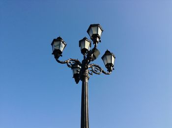 Low angle view of street light against clear blue sky