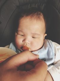 Close-up portrait of cute baby sleeping in bed