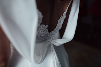 Close-up of woman wearing white dress