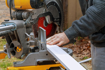 Close-up of man working on machine