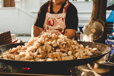 Midsection of woman preparing food in kitchen