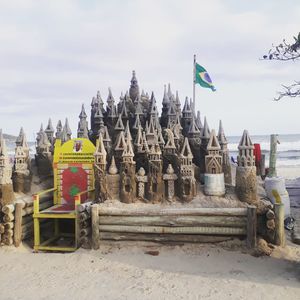 View of flags on beach against sky