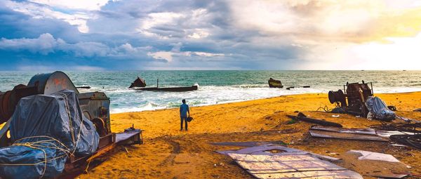 Scenic view of metal scrap on beach against sky