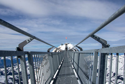 Footbridge over bridge against sky