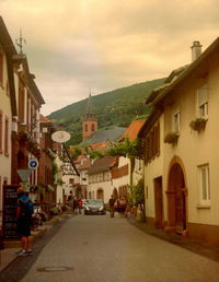 Street amidst buildings in town against sky