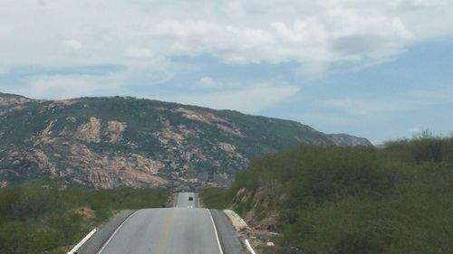 Country road leading towards mountains