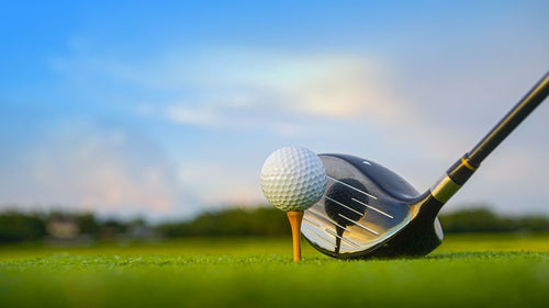Low section of person playing golf ball