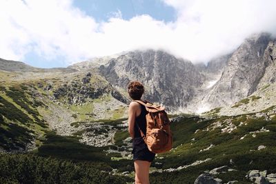 Rear view of a woman hiker looking into the mountains