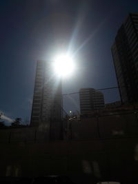 Low angle view of buildings against sky on sunny day