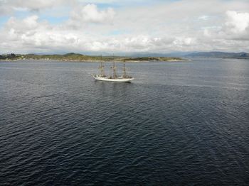 Sailboat sailing on sea against sky