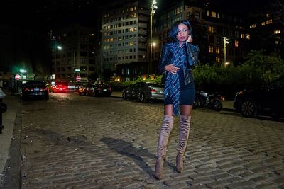 Portrait of man on street at night