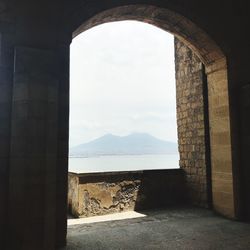 Interior of historic building by sea against sky 