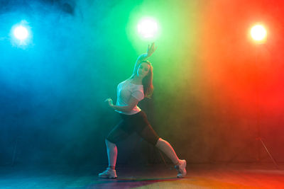 Full length of man dancing at illuminated nightclub